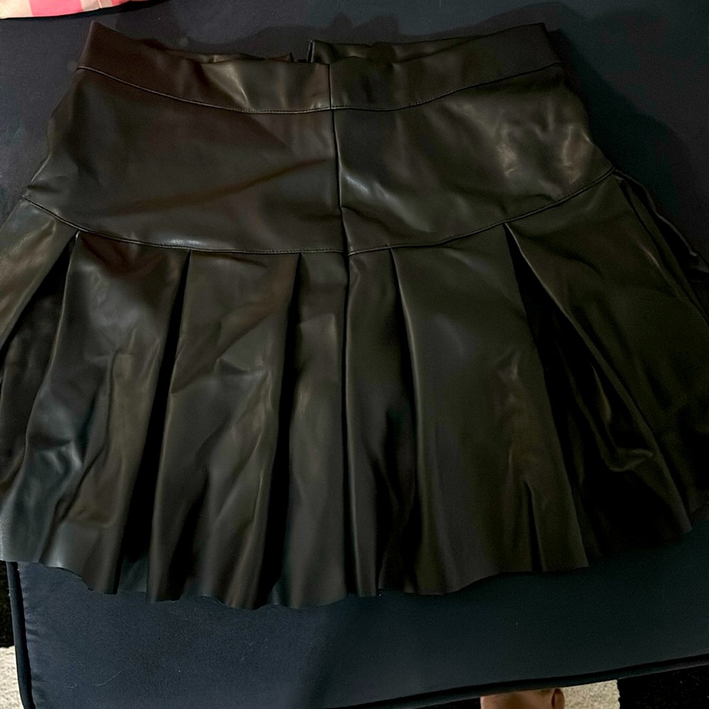 Black size medium pleated faux leather skirt never worn.